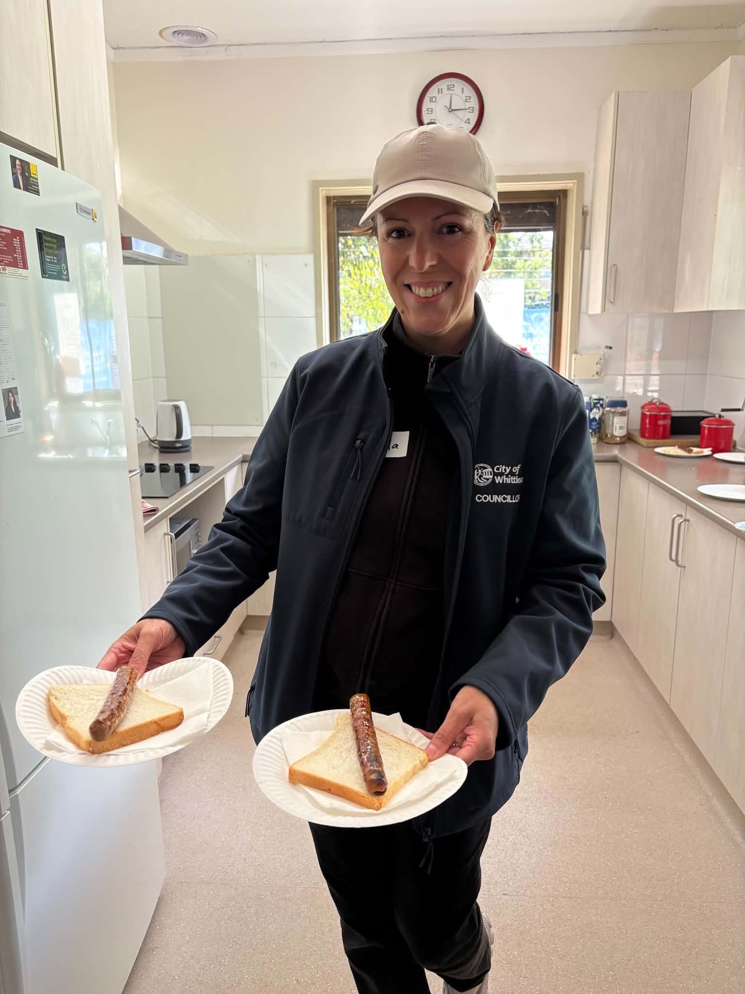 City of Whittlesea councillor serving sausage sandwiches in the kitchen